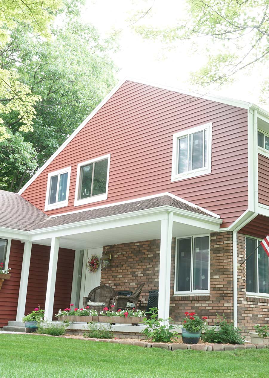 red house with new siding and replacement windows