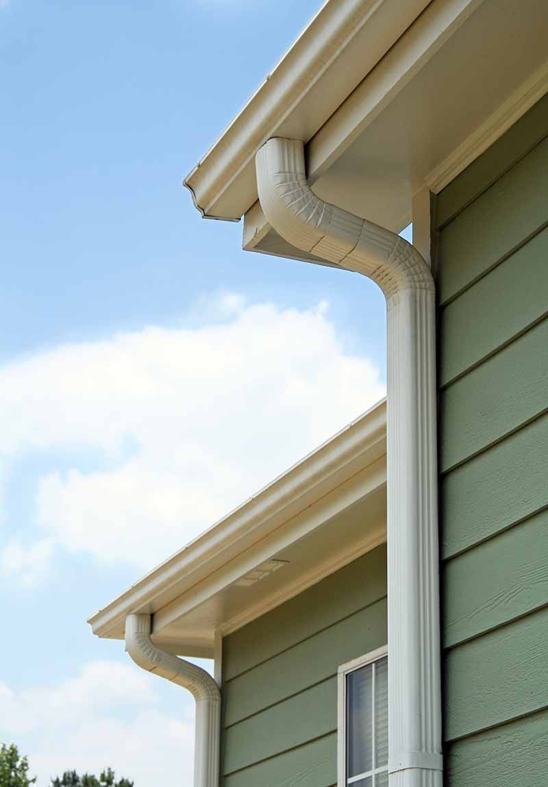 white k-style gutters and downspouts